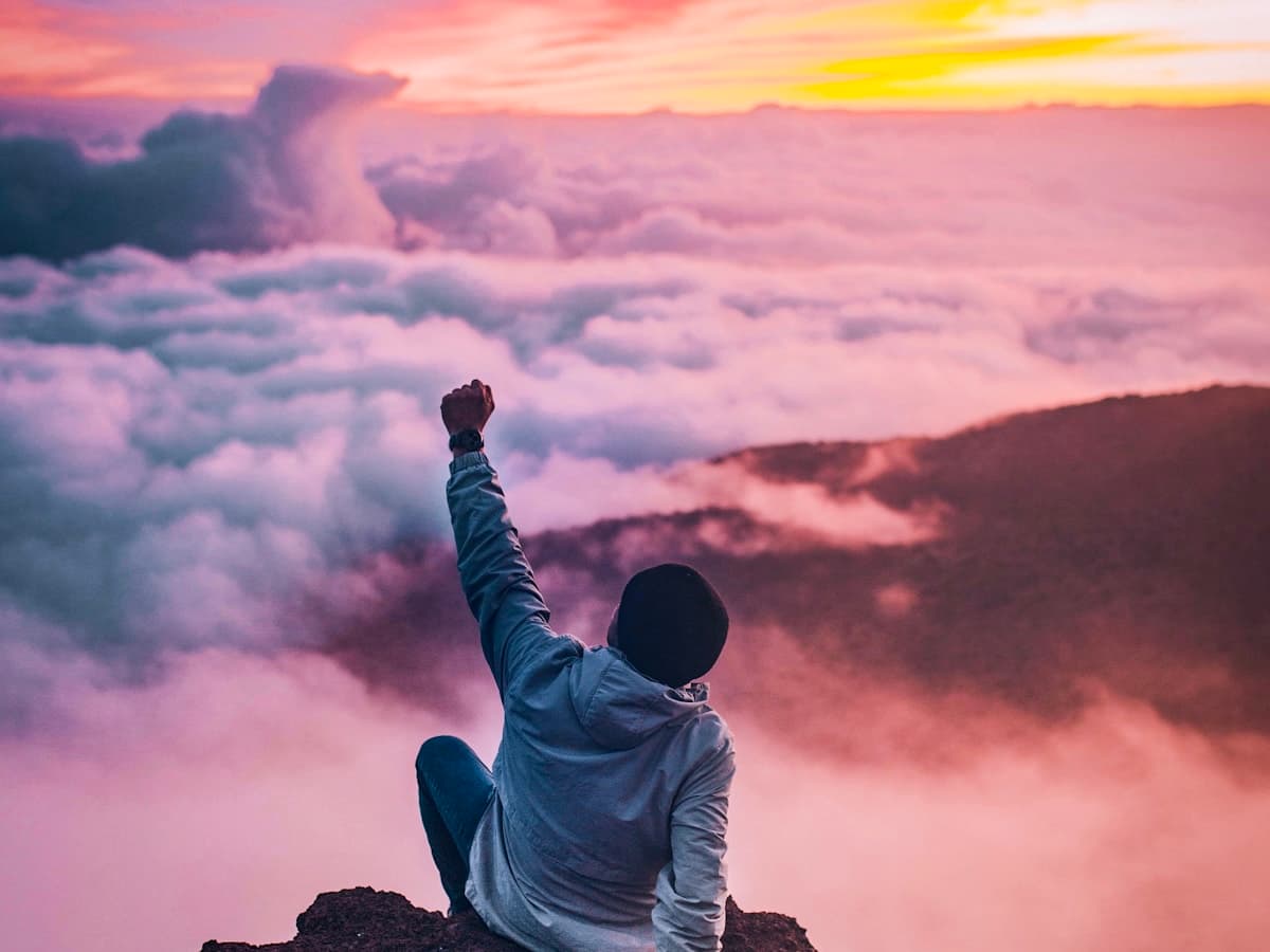 Traveler overlooking a mountain sea of clouds at sunrise in Canada