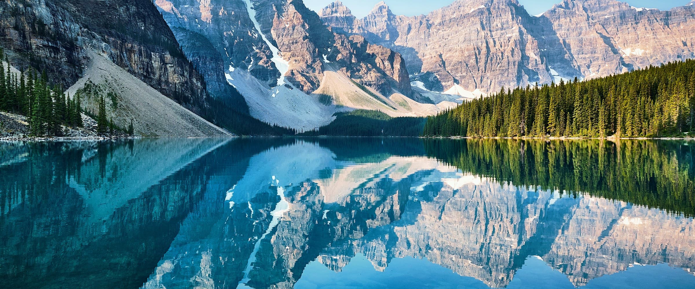 Wide panoramic view of Moraine Lake and the Canadian Rockies in Alberta